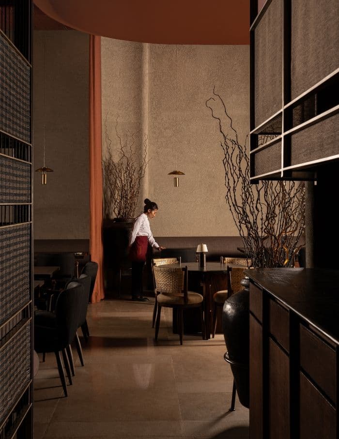 Front of house professional setting a table at an elegant restaurant in Perth, Western Australia